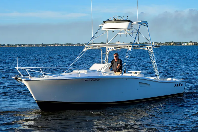 Slide: The Image of 1998 Aura 28 Tournament Series boat on open water, clear sky background. - 43