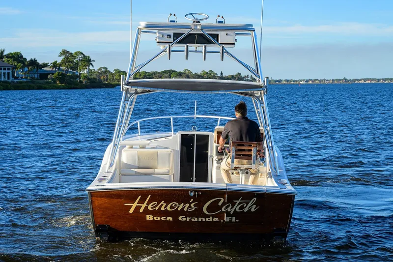 Slide: The Image of 1998 Aura 28 Tournament Series boat on water, labeled "Heron's Catch," Boca Grande, Florida. - 45