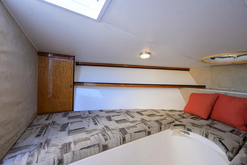 Slide: The Image of Cozy cabin interior of 1998 Aura 28 Tournament Series boat with patterned bedding and cushions. - 7