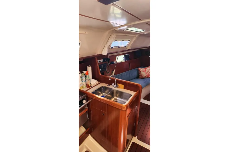 Slide: The Image of Interior of 1999 Beneteau Oceanis 321 sailboat with kitchen sink and seating area. - 22