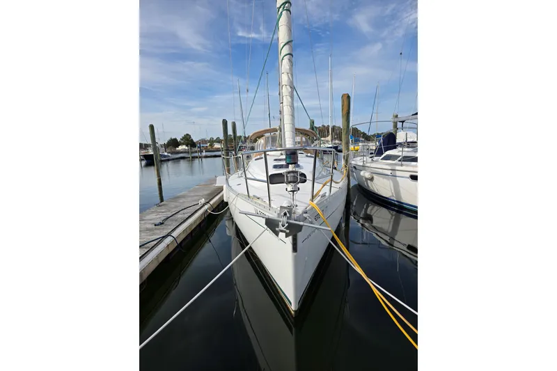 Slide: The Image of 1999 Beneteau Oceanis 321 sailboat docked at marina, calm water reflection. - 4
