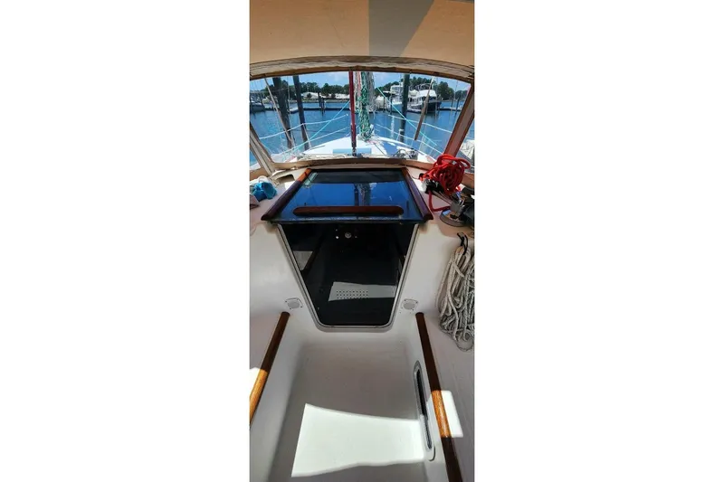 Slide: The Image of Interior view of 1999 Beneteau Oceanis 321 sailboat cockpit with marina background. - 8