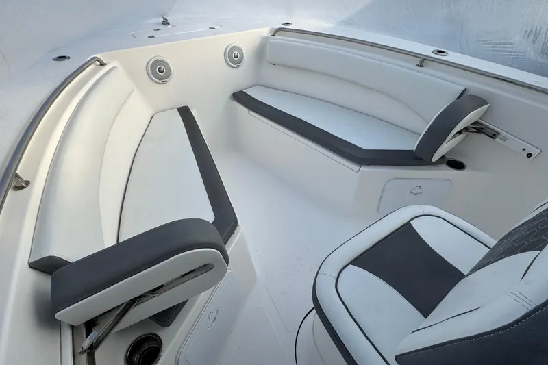 Slide: The Image of 2017 Tidewater 230 CC Adventure boat interior with cushioned seating and modern design. - 11