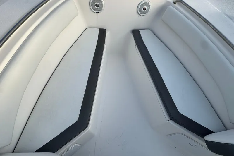 Slide: The Image of 2017 Tidewater 230 CC Adventure boat interior with cushioned seating and speakers. - 12