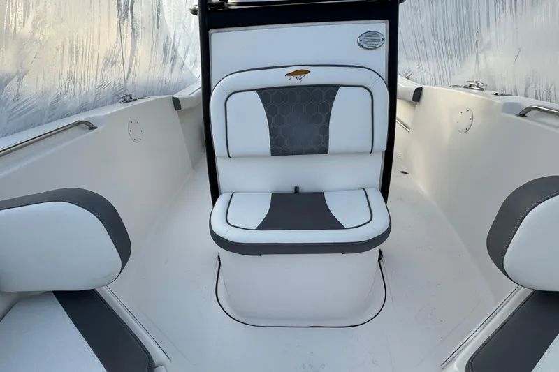 Slide: The Image of 2017 Tidewater 230 CC Adventure boat interior with cushioned seating. - 13