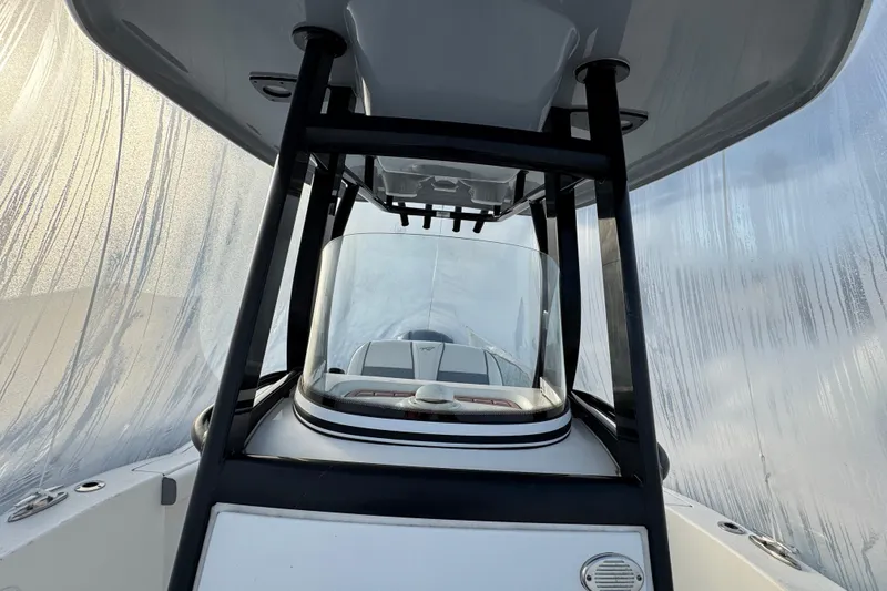 Slide: The Image of 2017 Tidewater 230 CC Adventure boat under protective cover, viewed from the helm. - 14