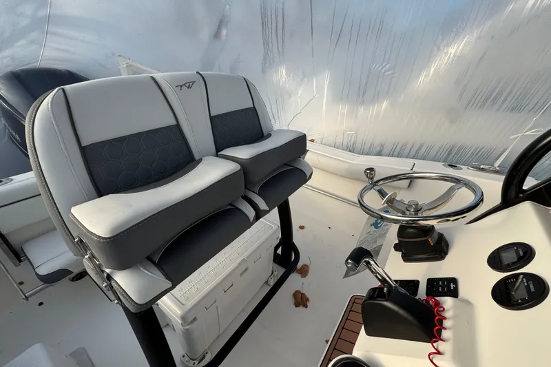 Slide: The Image of 2017 Tidewater 230 CC Adventure boat interior with dual seats and steering console. - 16