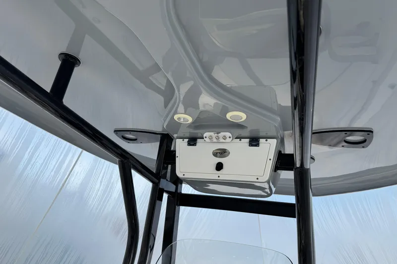 Slide: The Image of 2017 Tidewater 230 CC Adventure boat's T-top with mounted electronics and lighting. - 20