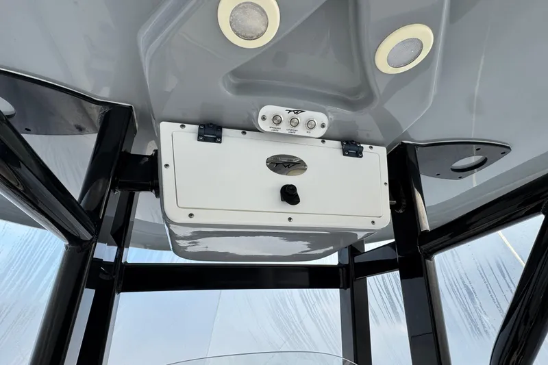 Slide: The Image of Tidewater 230 CC Adventure 2017 boat console with overhead storage and lighting. - 9