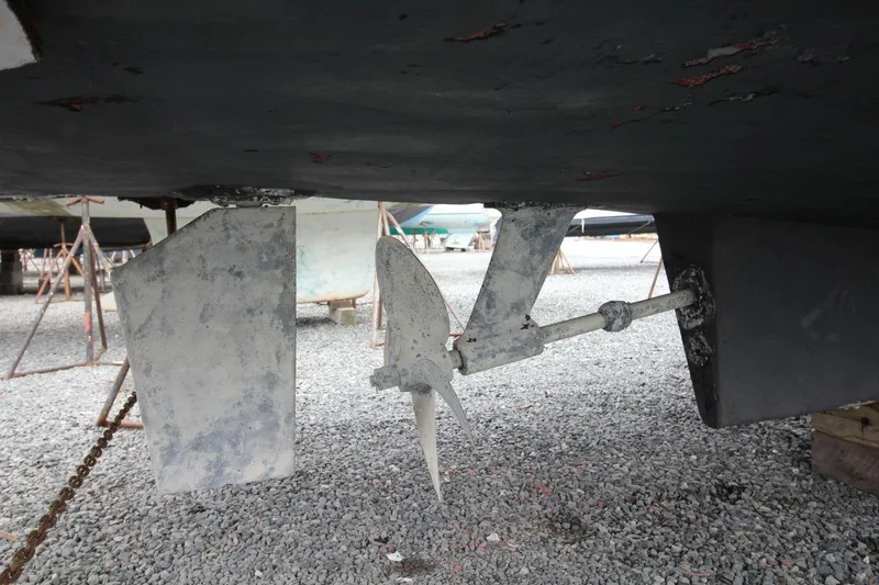 Slide: The Image of 2002 Mainship 390 Trawler deck with teak flooring and steps, docked near other boats. - 12