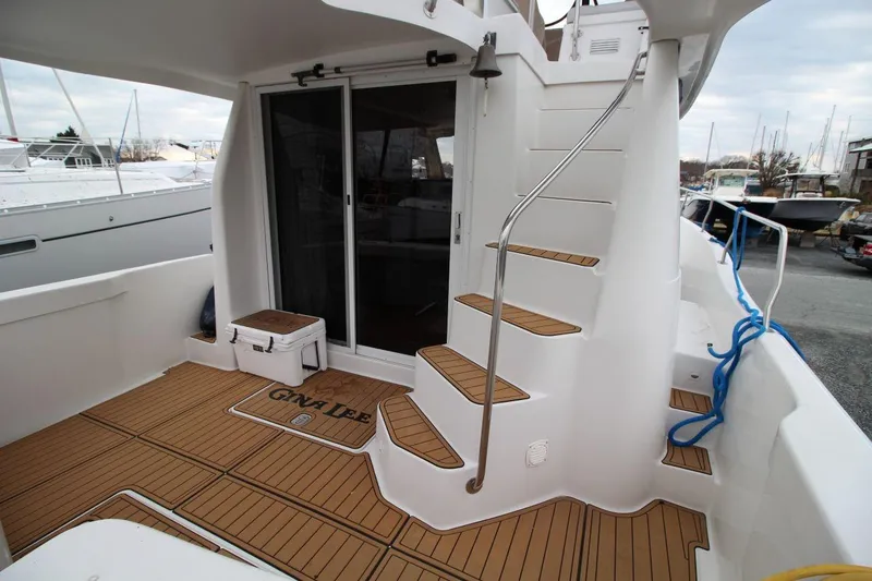 Slide: The Image of 2002 Mainship 390 Trawler with covered seating area and marina view. - 14