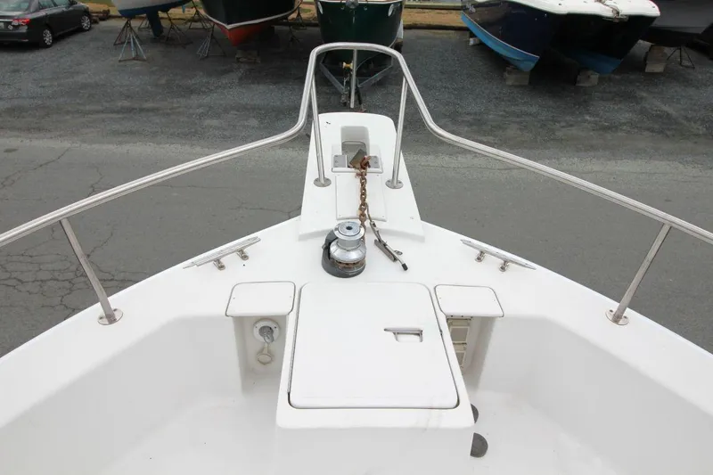 Slide: The Image of 2002 Mainship 390 Trawler interior with cushioned seating and control panel. - 17