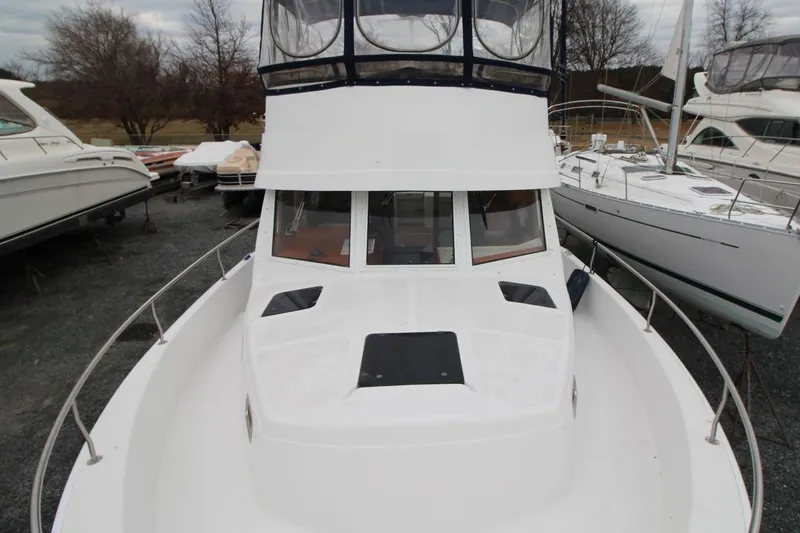 Slide: The Image of Helm of 2002 Mainship 390 Trawler with steering wheel and navigation instruments. - 18