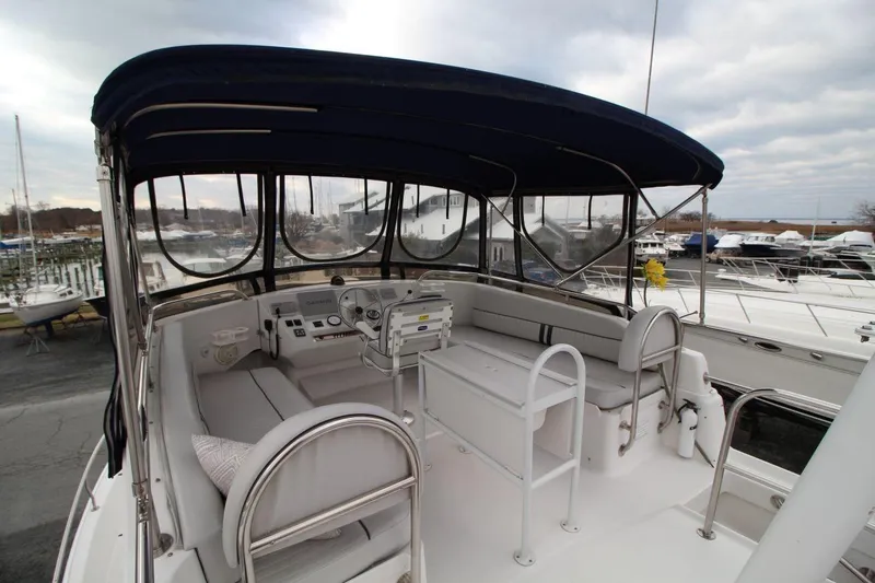 Slide: The Image of 2002 Mainship 390 Trawler, side view with windows and deck details. - 22