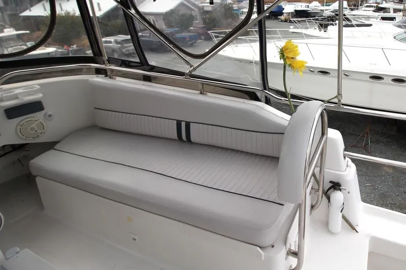 Slide: The Image of Captain's chair on 2002 Mainship 390 Trawler, featuring sleek gray upholstery. - 23