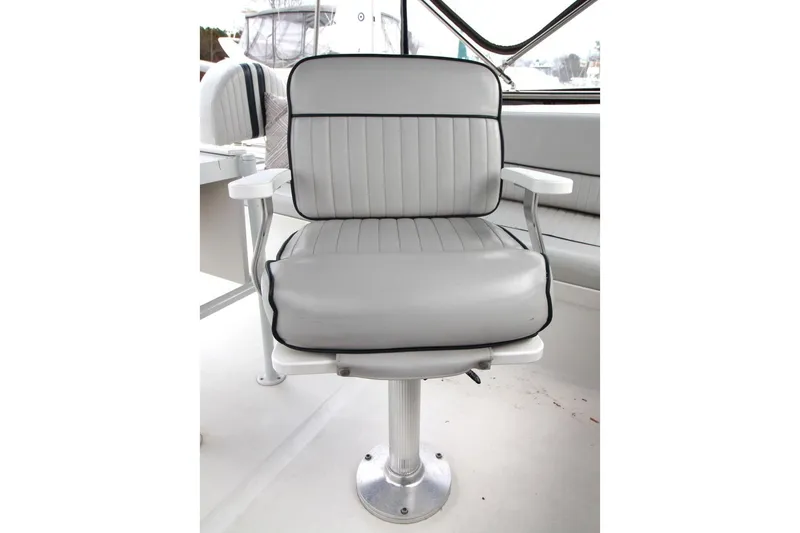 Slide: The Image of 2002 Mainship 390 Trawler interior with kitchen, seating, and helm station. - 25