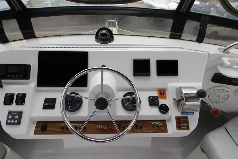 Slide: The Image of 2002 Mainship 390 Trawler kitchen with wood cabinetry, stove, and sink. - 26