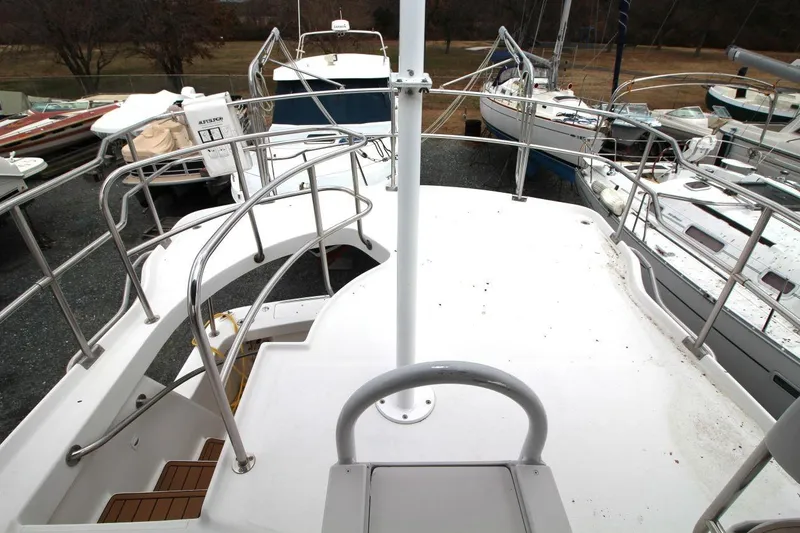 Slide: The Image of 2002 Mainship 390 Trawler kitchen with wood cabinets, TV, microwave, and oven. - 27