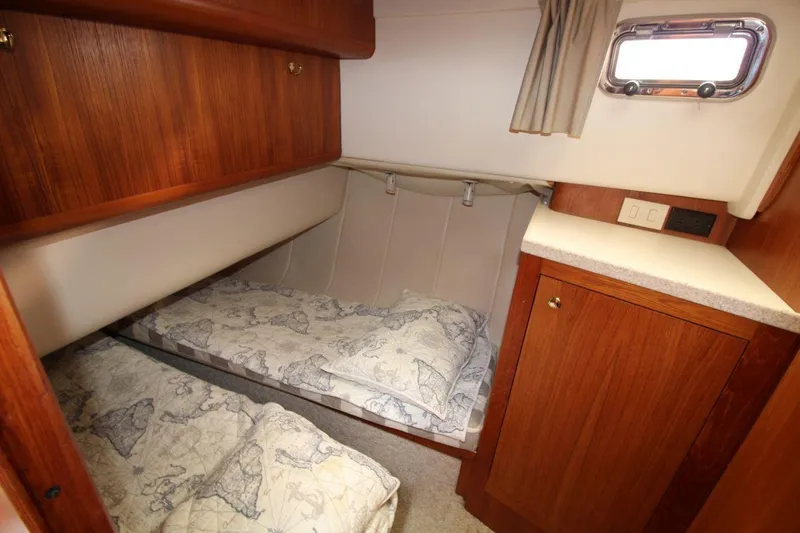 Slide: The Image of Engine room of a 2002 Mainship 390 Trawler, showcasing mechanical components and equipment. - 34