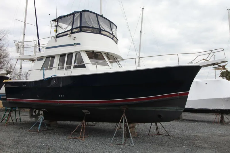 Slide: The Image of Top view of a 2002 Mainship 390 Trawler with blue canopy. - 6