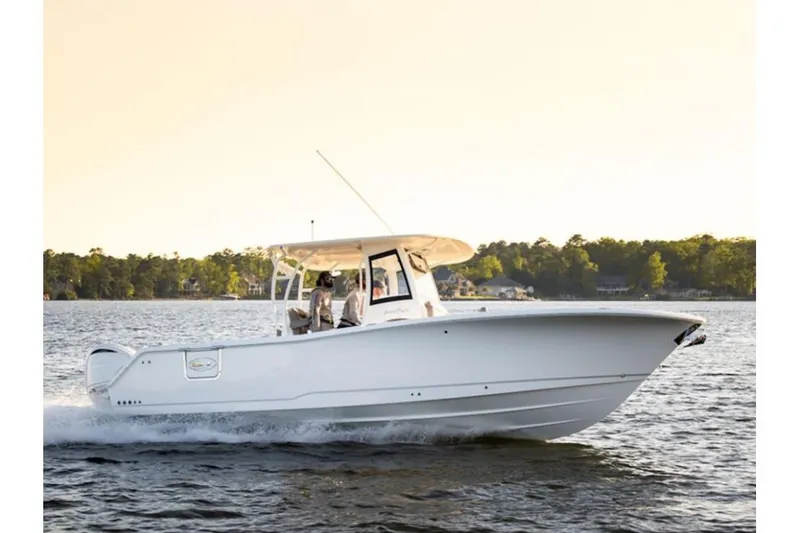 The Image of 2026 Sea Hunt Gamefish 28 Forward Seating boat cruising on a serene lake. - 1