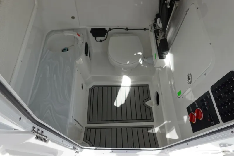 Slide: The Image of 2026 Sea Hunt Gamefish 28 Forward Seating boat interior with toilet and control panel. - 41