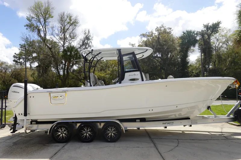 Slide: The Image of 2026 Sea Hunt Gamefish 28 Forward Seating boat on trailer, side view. - 5