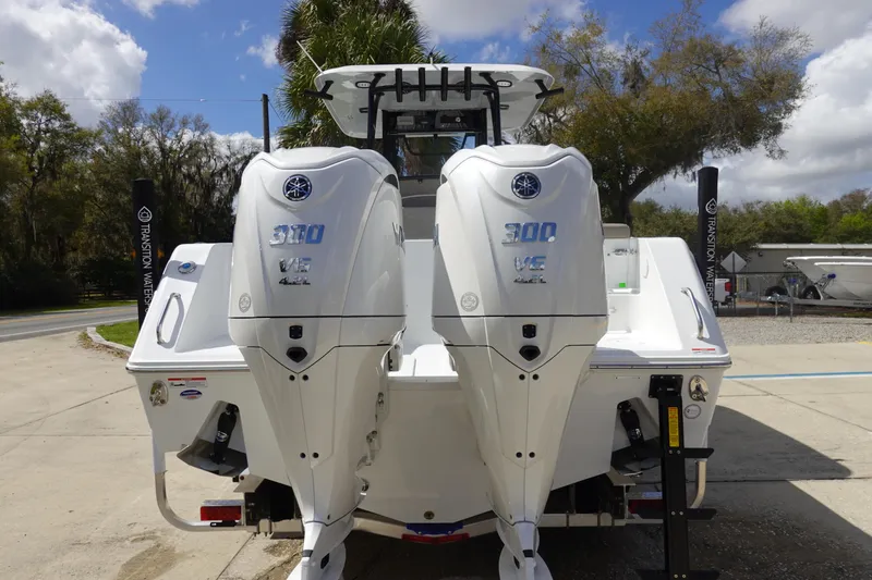 Slide: The Image of 2026 Sea Hunt Gamefish 28 with twin Yamaha 300 engines, parked outdoors. - 6