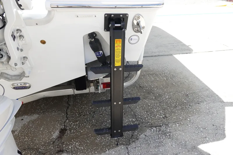 Slide: The Image of 2026 Sea Hunt Gamefish 28 boat ladder detail on concrete surface. - 7