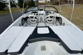 Slide: The Image of 2022 Tahoe 200 S boat interior with white and black cushioned seating. - 16