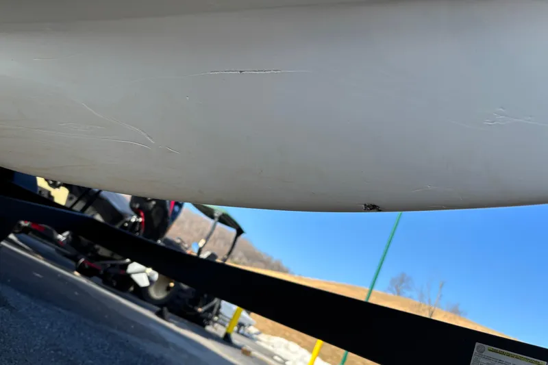 Slide: The Image of 2022 Tahoe 200 S boat hull with visible scratches and minor damage. - 25
