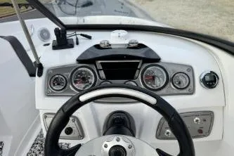 Slide: The Image of Dashboard of a 2022 Tahoe 200 S boat with steering wheel and gauges. - 26