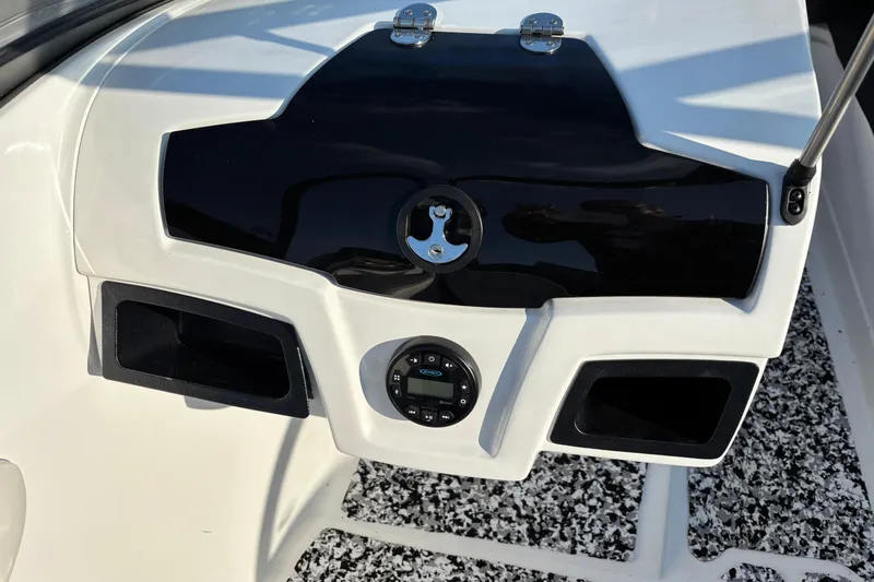 Slide: The Image of 2022 Tahoe 200 S boat dashboard with storage compartments and control panel. - 27