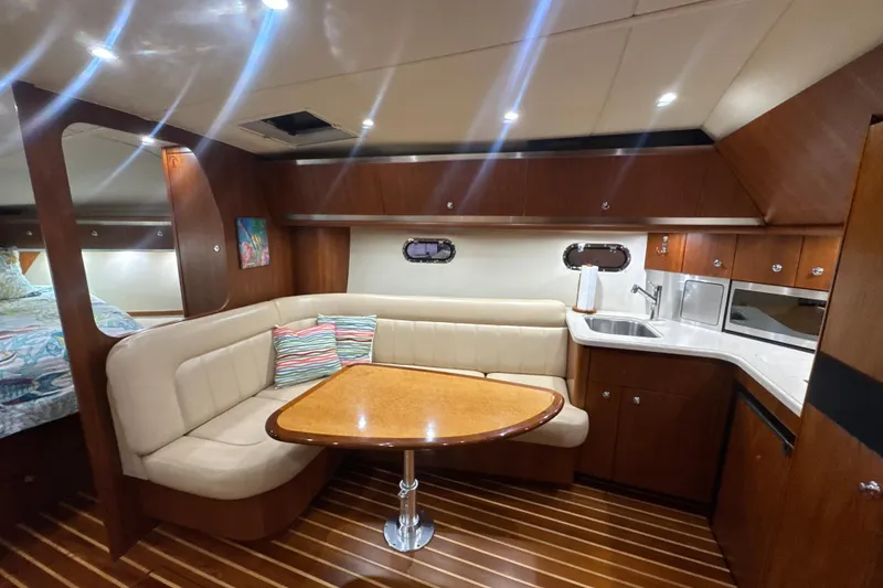 Slide: The Image of Luxurious 2006 Tiara Yachts 3600 Sovran interior with elegant seating and modern kitchenette. - 10