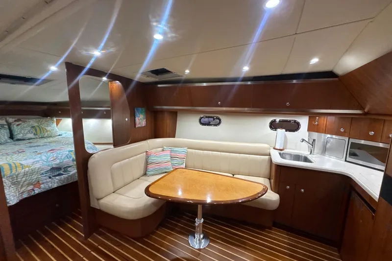 Slide: The Image of Luxurious interior of 2006 Tiara Yachts 3600 Sovran with cozy seating and kitchenette. - 11