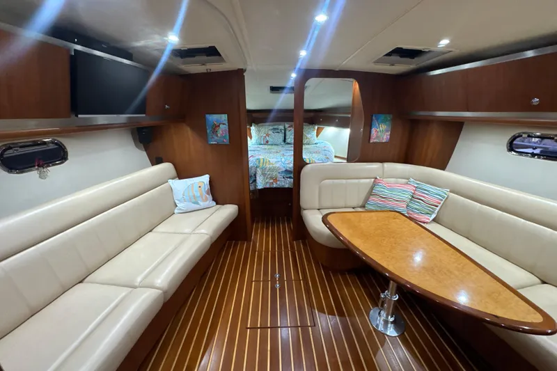 Slide: The Image of Luxurious interior of 2006 Tiara Yachts 3600 Sovran with elegant seating and wood finishes. - 13