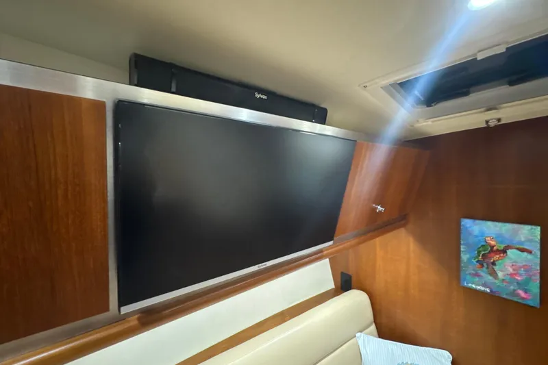 Slide: The Image of Interior of 2006 Tiara Yachts 3600 Sovran with TV and artwork on wooden paneling. - 19