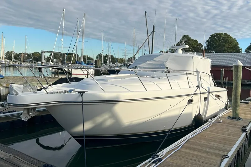 Slide: The Image of 2006 Tiara Yachts 3600 Sovran docked at a marina under a partly cloudy sky. - 2