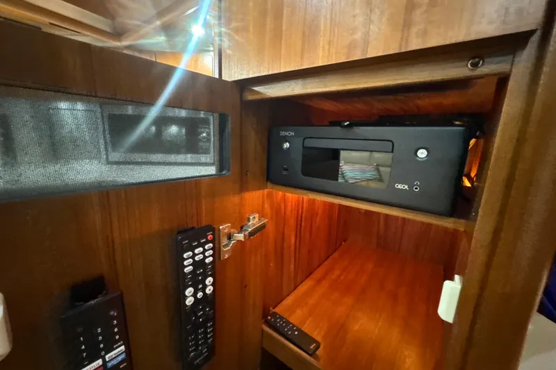 Slide: The Image of 2006 Tiara Yachts 3600 Sovran interior with Denon audio system and remote controls. - 20