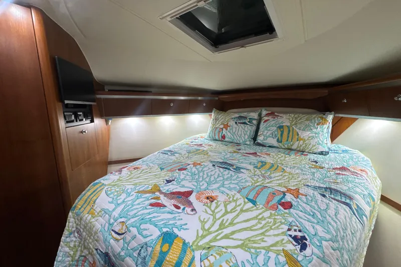 Slide: The Image of 2006 Tiara Yachts 3600 Sovran cabin with colorful marine-themed bedding and wood accents. - 24