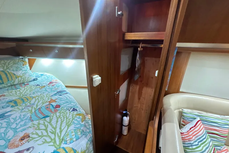 Slide: The Image of Interior of 2006 Tiara Yachts 3600 Sovran with colorful bedding and wooden cabinetry. - 28