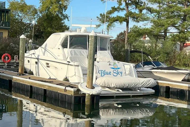 Slide: The Image of 2006 Tiara Yachts 3600 Sovran "Blue Sky" docked at marina with trees in background. - 3