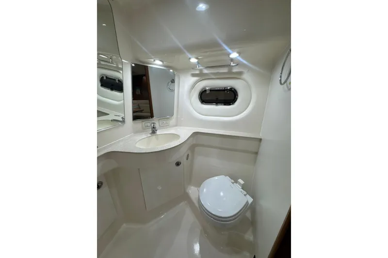 Slide: The Image of 2006 Tiara Yachts 3600 Sovran bathroom with sink, toilet, and porthole window. - 30