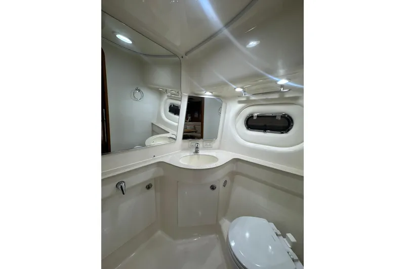 Slide: The Image of Luxurious bathroom in 2006 Tiara Yachts 3600 Sovran with modern fixtures and porthole window. - 31