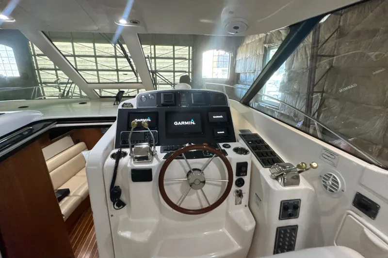 Slide: The Image of 2006 Tiara Yachts 3600 Sovran helm with Garmin navigation system and wooden steering wheel. - 32