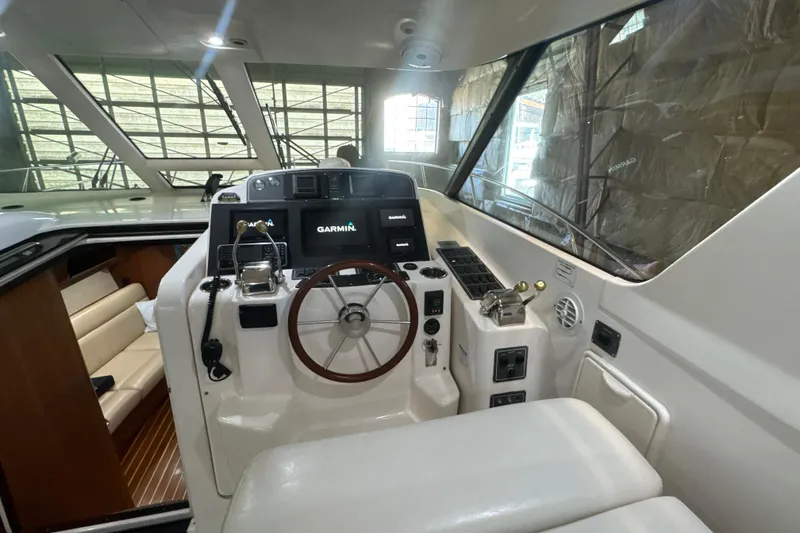 Slide: The Image of 2006 Tiara Yachts 3600 Sovran helm with Garmin navigation system and luxurious interior seating. - 33