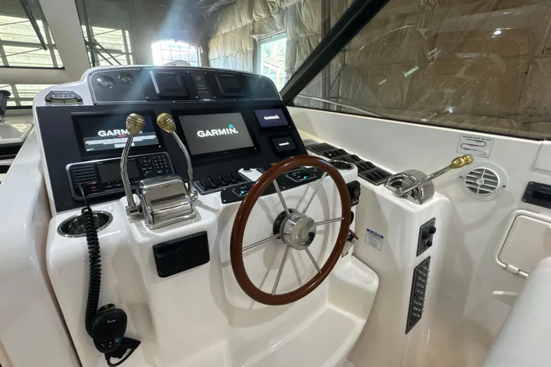 Slide: The Image of 2006 Tiara Yachts 3600 Sovran helm with Garmin navigation displays and wooden steering wheel. - 35
