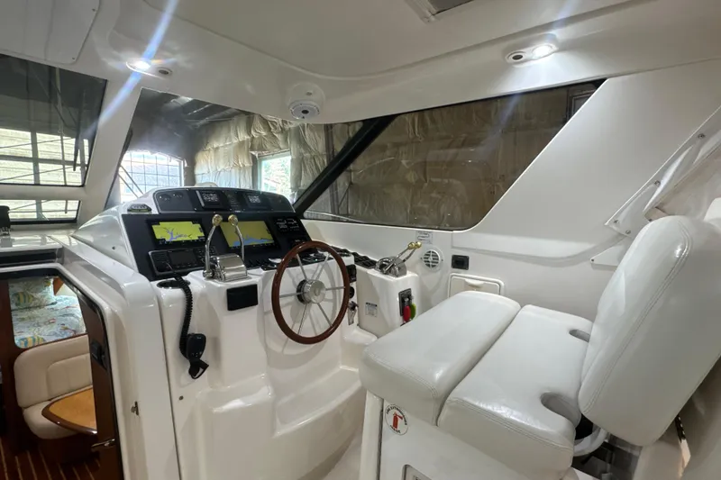 Slide: The Image of 2006 Tiara Yachts 3600 Sovran helm with navigation displays and white seating. - 40