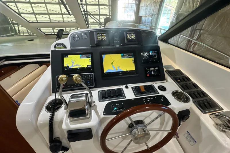 Slide: The Image of 2006 Tiara Yachts 3600 Sovran helm with navigation screens and controls. - 42