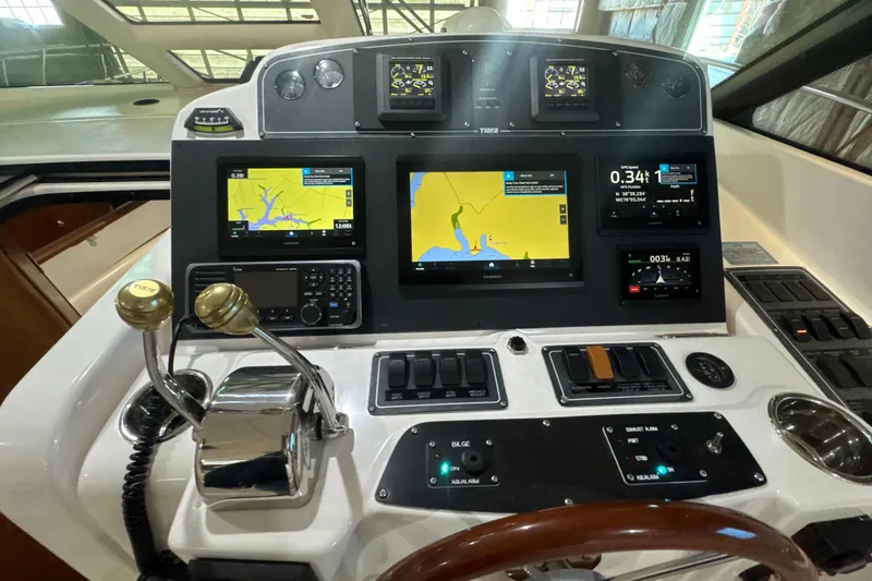 Slide: The Image of 2006 Tiara Yachts 3600 Sovran helm with navigation screens and controls. - 43